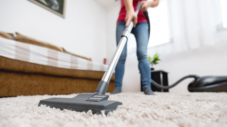 vacuuming the carpet