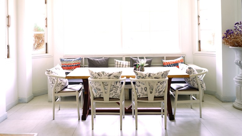 Dining room with banquette seating on one half of the table