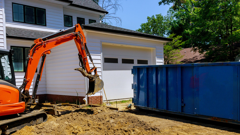 Dumpster next to renovated home 