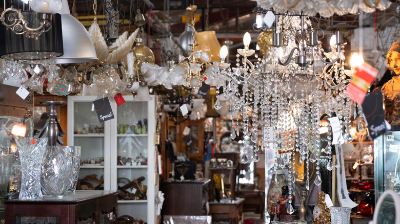Lamps and glass chandeliers hanging in secondhand store