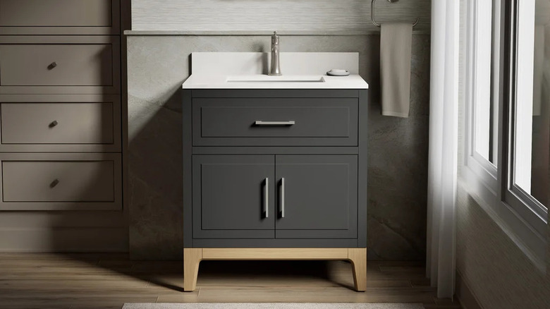 Kohler's Tio Bathroom Vanity Cabinet in a moody, contemporary bathroom setting