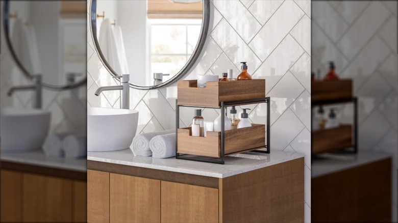 Seville Classics' 2-tier Acacia Sliding Bin Organizer next to a bathroom sink