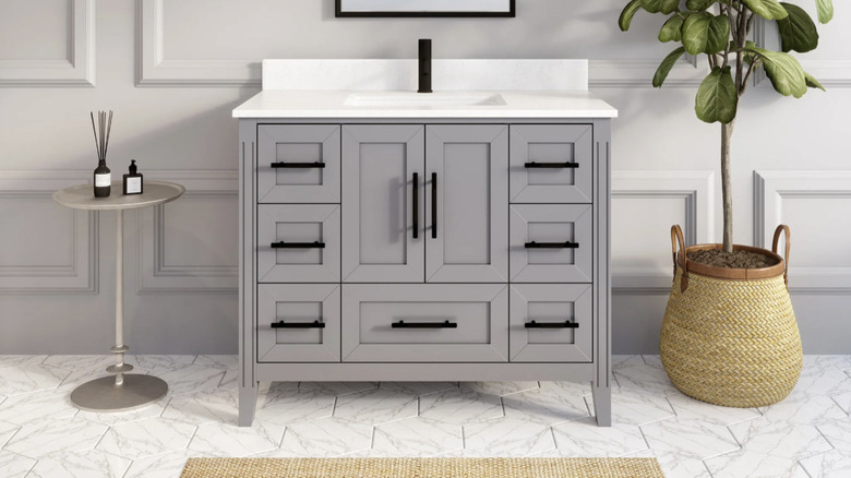 Studio Bathe's Hudson Gray Bath Vanity Unit in a contemporary bathroom setting with a plant and side table
