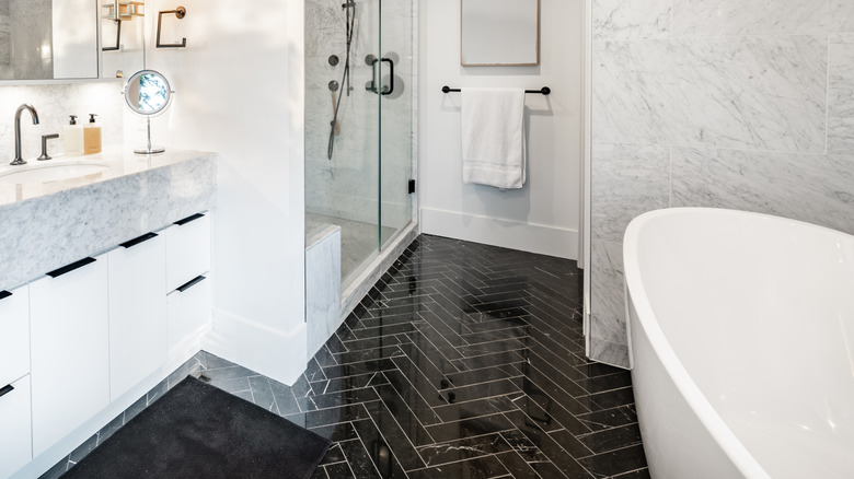 White bathroom with black floor tile
