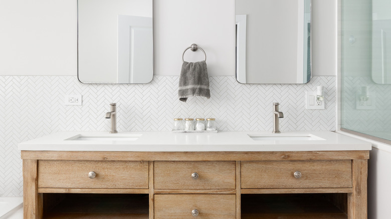 Bathroom with wood cabinets, white countertop and silver hardware