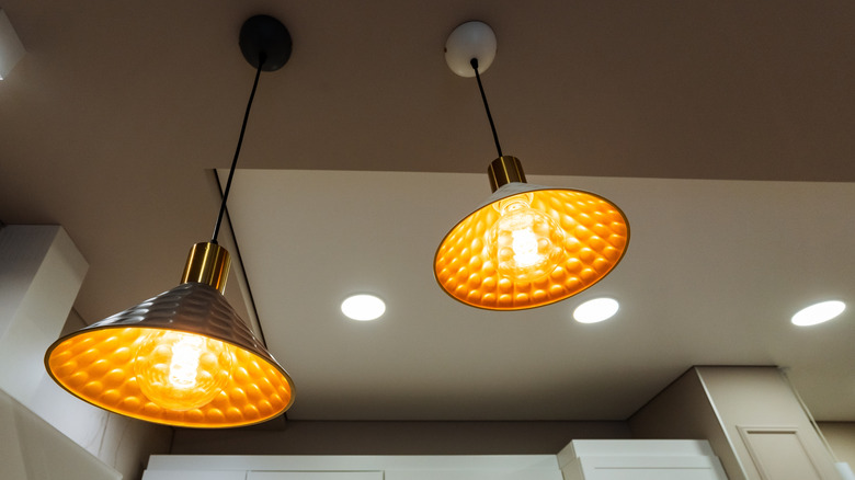 Two pendant lights beneath recessed ceiling lights