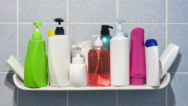 A shelf laden with shampoo bottles in a bathroom