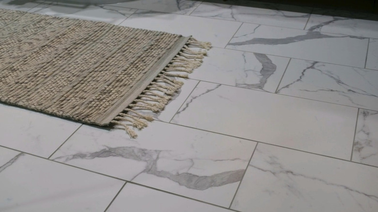 A rug on marble tiles
