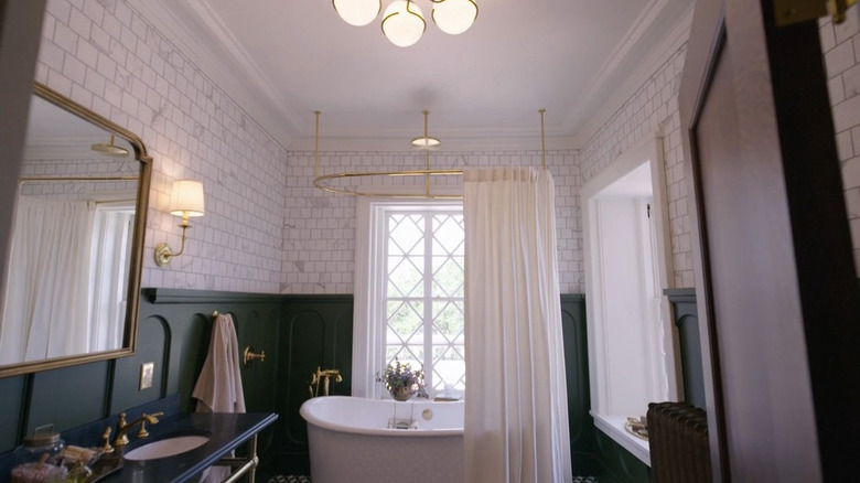 A sink and bathtub in a green and white bathroom