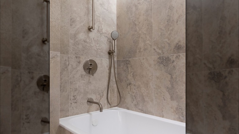 Shower with large, square travertine tiles