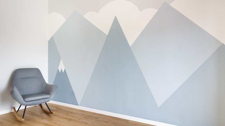 Basic mountain mural on wall with chair in corner