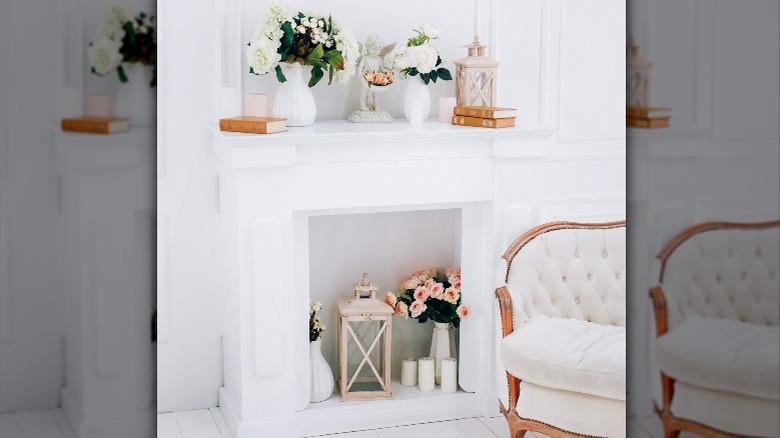 White fireplace with flower bouquets