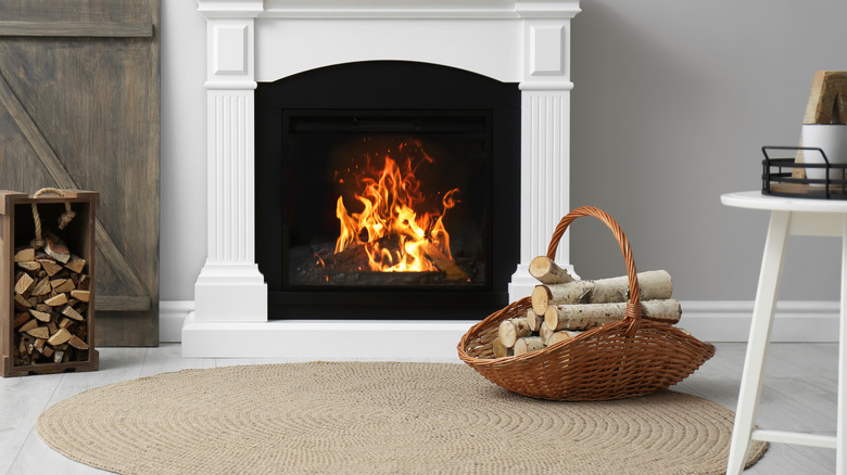 Wooden logs near a fireplace