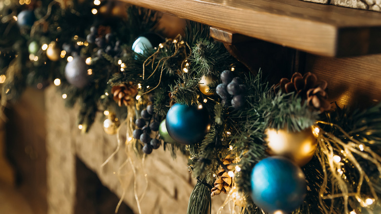 Blue ornaments on a holiday mantel decoration work for both Hanukkah and Christmas.
