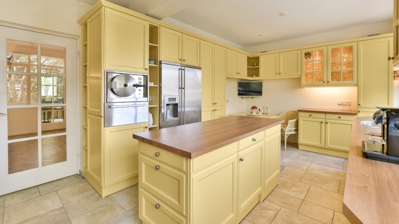 Yellow kitchen island and cabinets