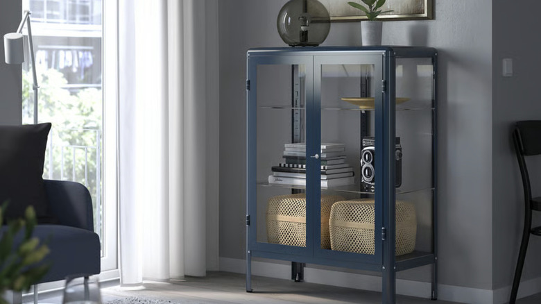 Light blue storage cabinet with decorative items inside