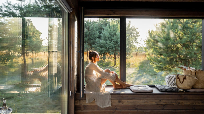 Woman sitting on window seat