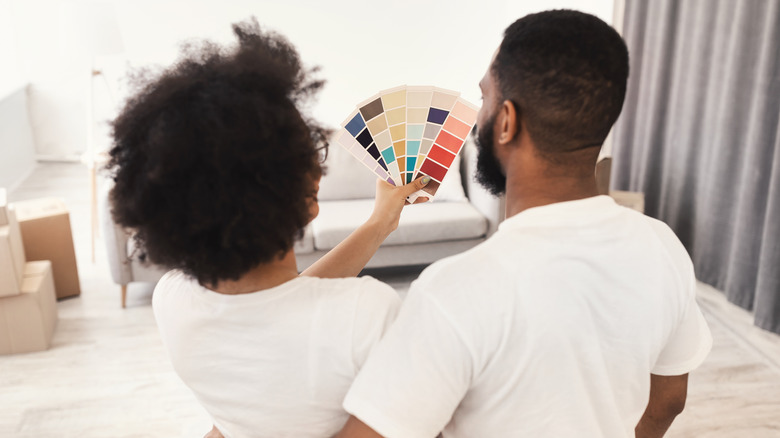 Couple holding paint swatches