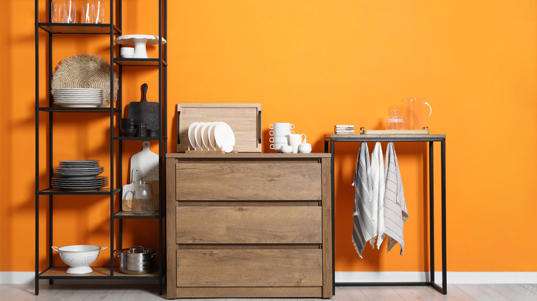 A dresser stocked with kitchen plates and cups