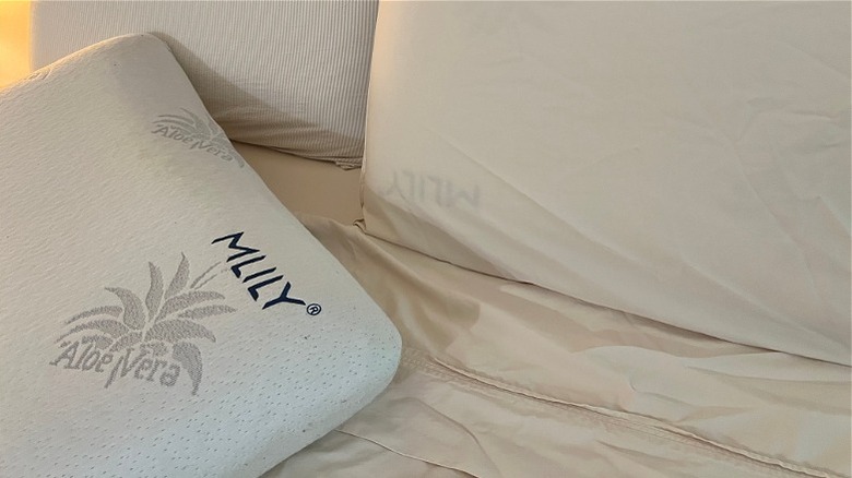 Bare MLILY brand pillow on a partially made bed with beige Bedsure sheets