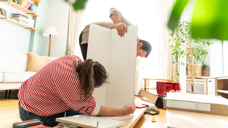 Picture of a couple assembling a shelving unit