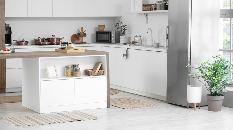 A kitchen with an island with plenty of storage