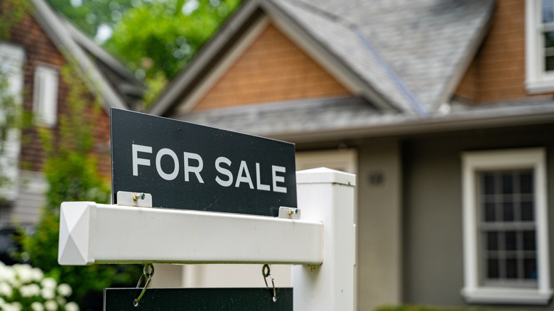 A for sale sign in front of a house