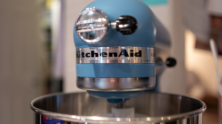 A blue KitchenAid mixer in a kitchen