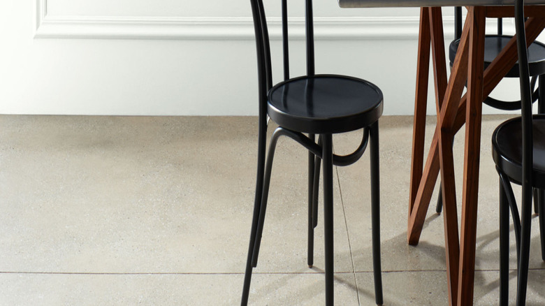Dark neutral dining set against ivory wall.