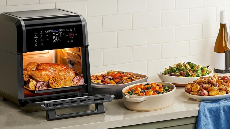 A large Chefman air fryer baking a turkey and other holiday foods