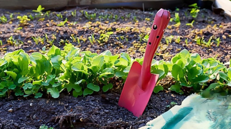 One of Newflager's Colorful Metal Hand Shovels in soil