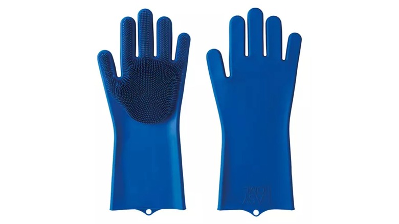 A pair of blue silicone scrub gloves with scrubbing bristles on the palm and fingers of the glove