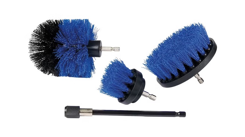 A navy blue brush set with three different hard-bristled brushes