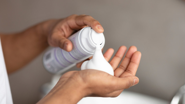 spraying bottle of shaving cream