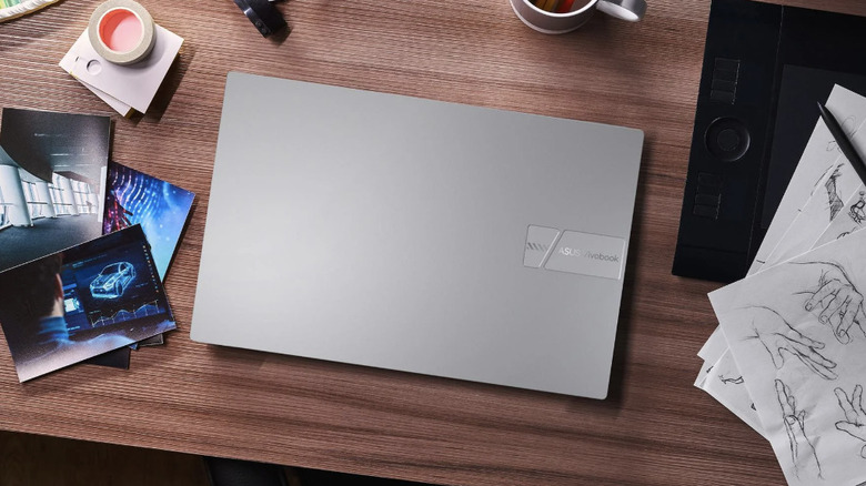 ASUS Vivobook closed on a desk with random items