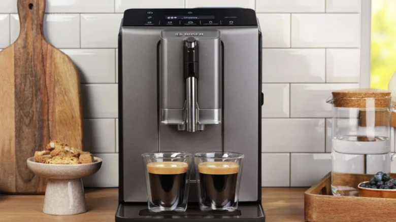 Bosch 300 Espresso and Coffee machine sitting on a counter next to a cutting board and breakfast tray