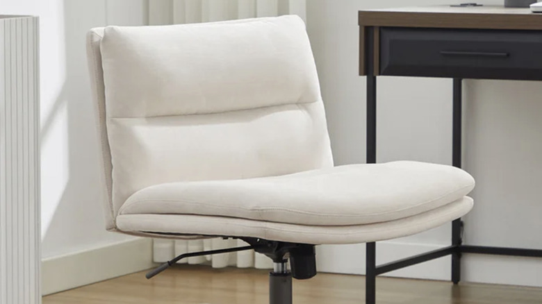 Elle decor criss cross chair next to a desk in an office