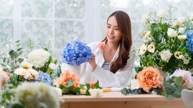 Person arranging a bouquet 