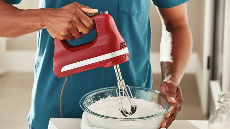 A close up of the beaters on a KitchenAid hand mixer.