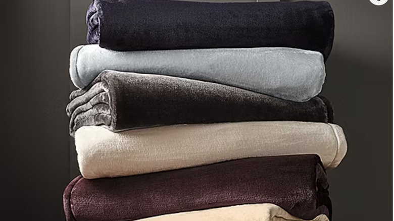 A colorful stack of velvet blankets.