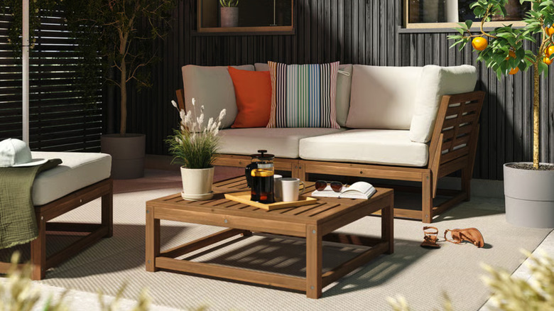 Outdoor patio with the NÄMMARÖ Loveseat, ottoman, and coffee table
