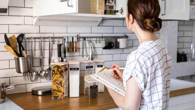 woman organizing items in kitchen