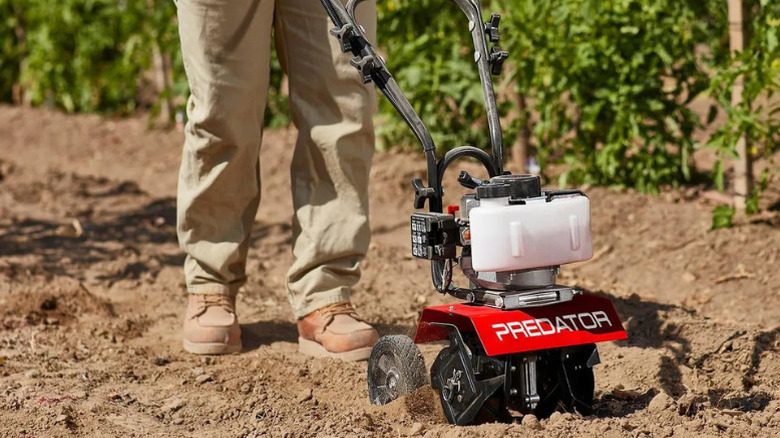 A person using a lawn cultivator