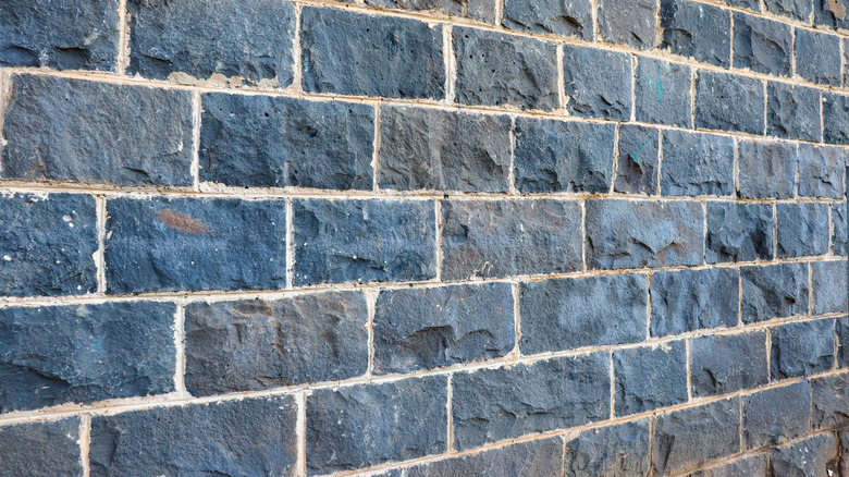 Bricks of bluestone form a wall