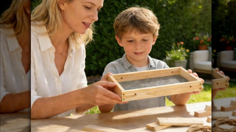 A mom and son building Lukvuzo's DIY picnic table bird feeder