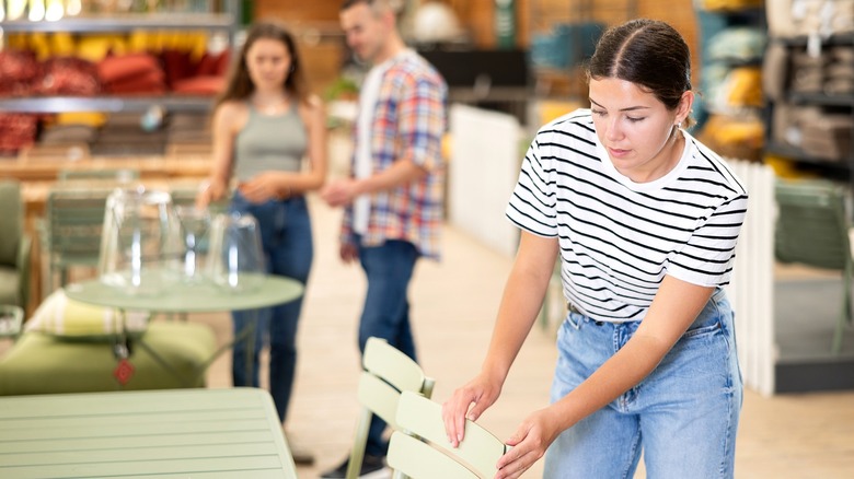 Woman shopping for patio furniture in store