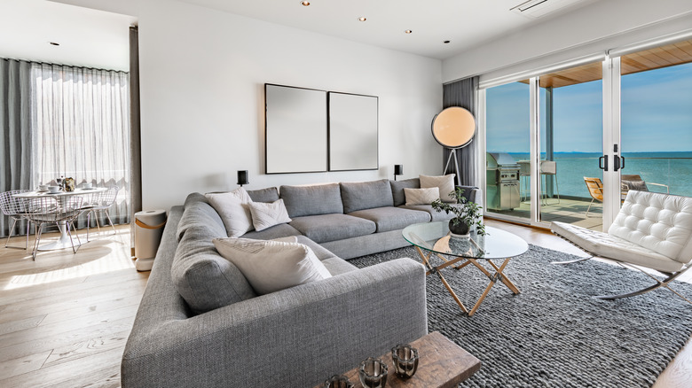 An open living room featuring a gray sectional couch.