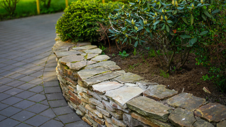 Stone retaining wall doubling as a planter