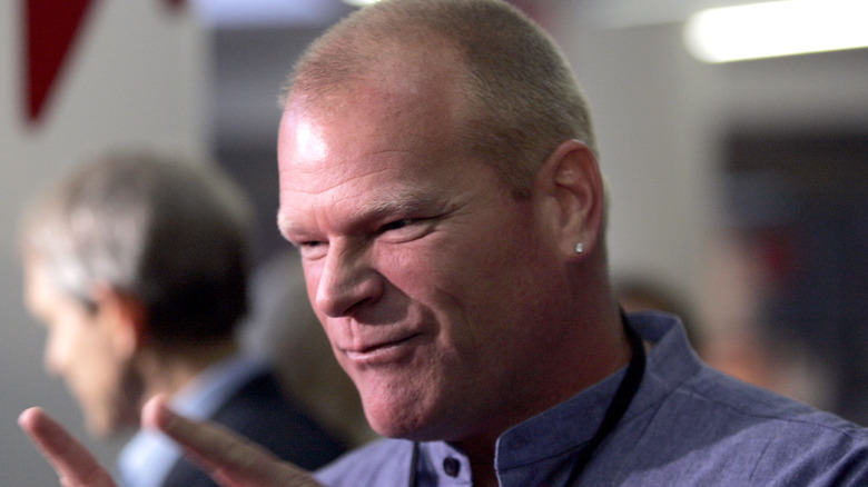 Mike Holmes wearing a blue shirt with a black lanyard
