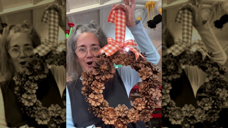 A wreath made of pine cones and ribbon